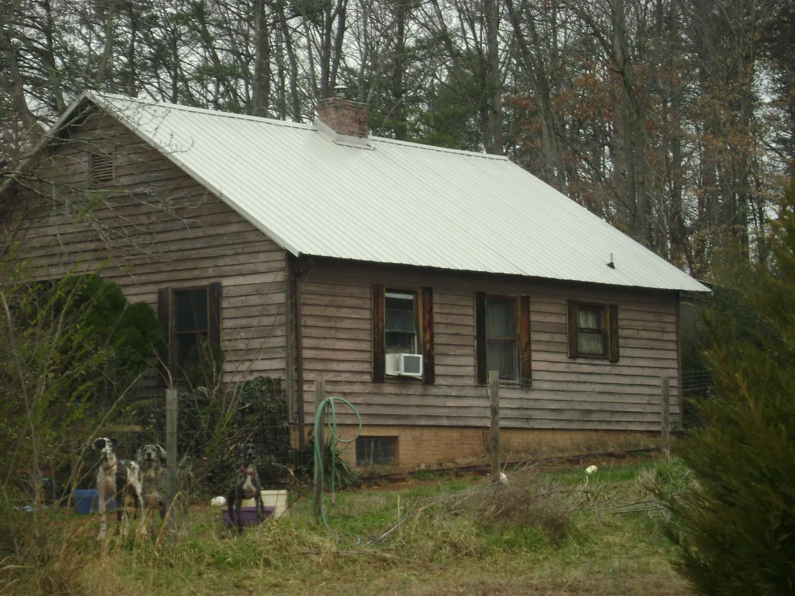 White metal roof on an old wood sided farmhouse, from a Metal Roof Installation job in Barnum
